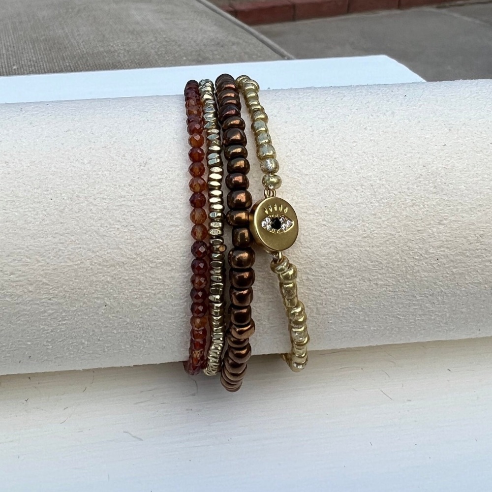 Gold and copper bangle bracelet set of 4 with evil eye charm